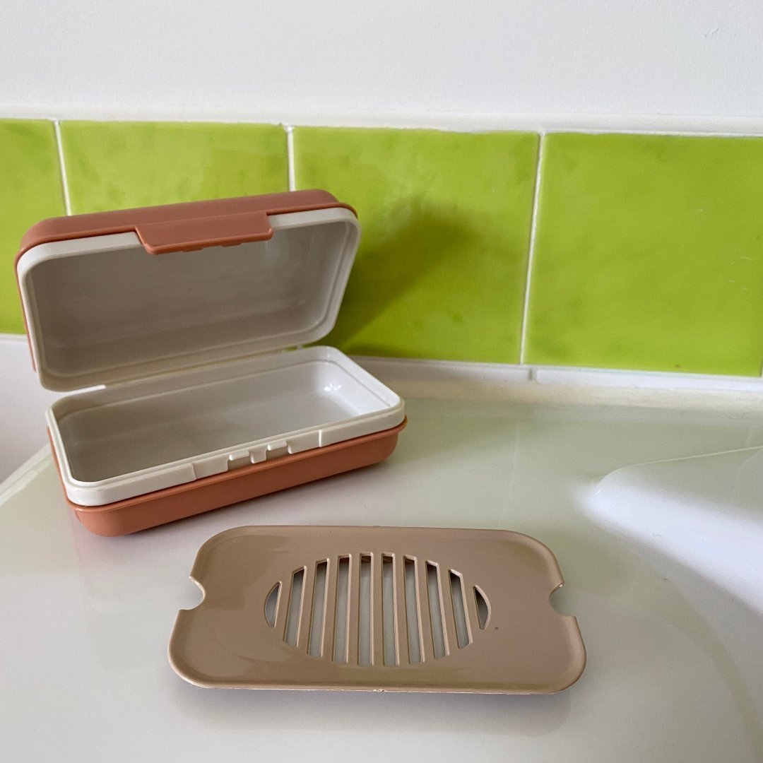 Lightweight soap holder case with drip tray to prevent moisture buildup, designed for travel.