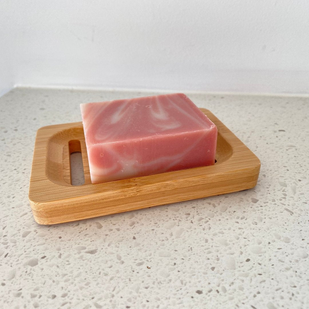 Side angle of bamboo soap holder showcasing the design that prevents water buildup and keeps soap from softening.