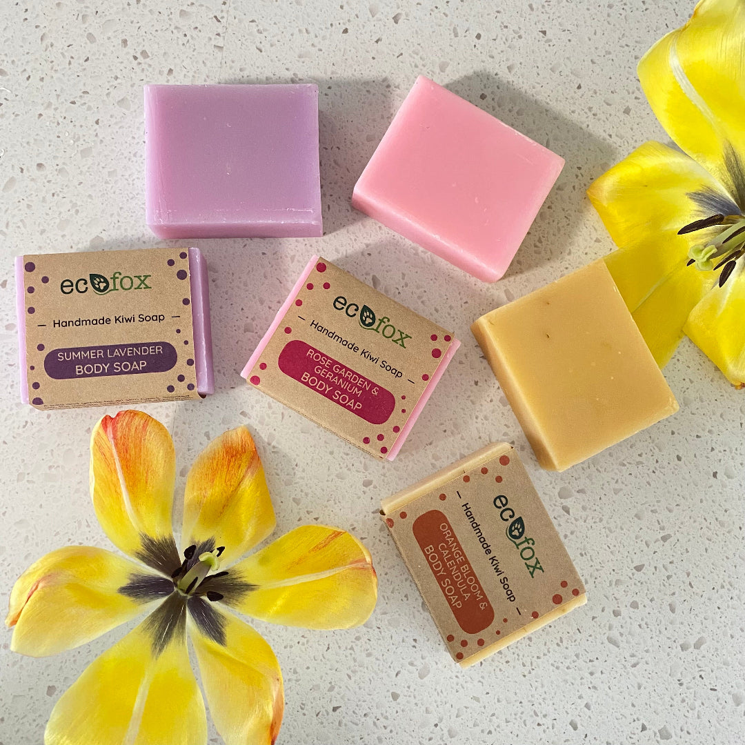 Close-up of Eco Fox floral soap trio: Orange Bloom & Calendula, Rose Garden & Geranium, and Summer Lavender soaps.