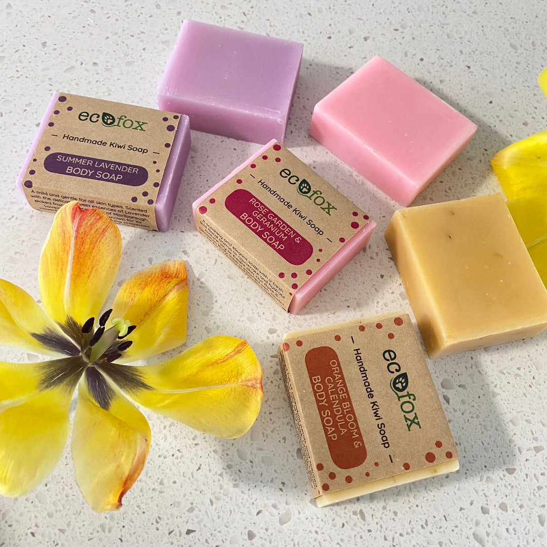 Three Eco Fox handmade body soaps — Orange Bloom & Calendula, Rose Garden & Geranium, Summer Lavender — beautifully displayed.