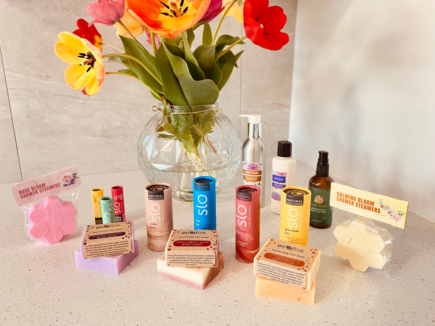 A beautifully arranged display of Eco Fox handmade soap, shampoo, and conditioner bars surrounded by natural eco-friendly accessories.