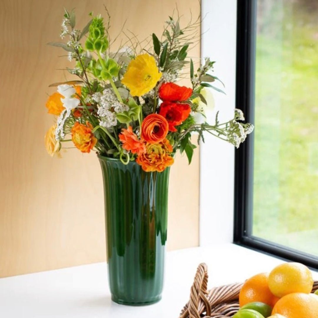 Elevate your space with the Eden planter vases. Crafted from 100% ceramic with ribbed detailing and a glossy olive glaze.