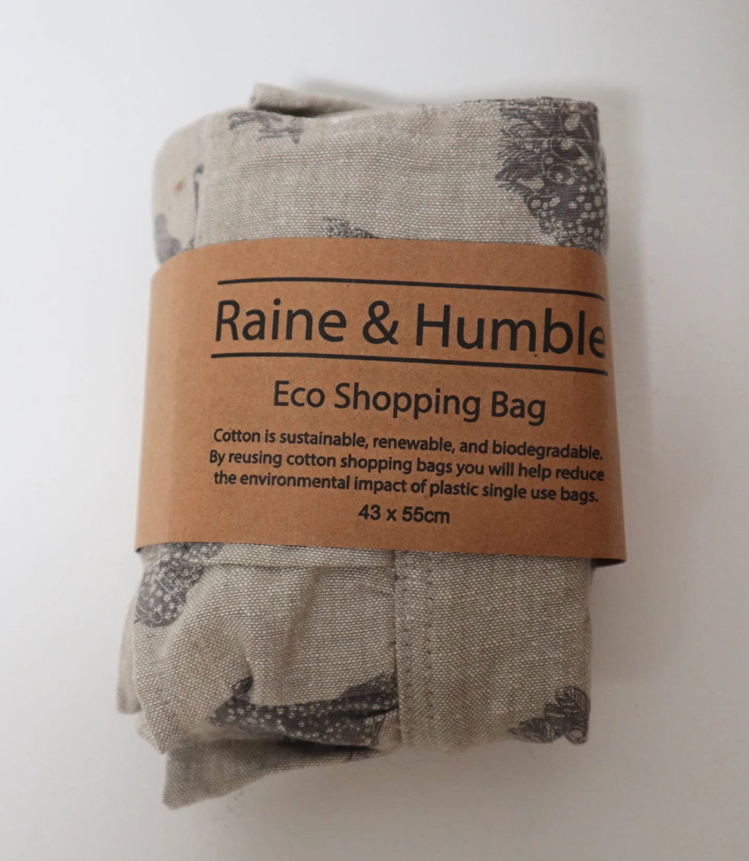 Close-up of the Henrietta Shopping Tote Bag – Ash neatly folded in its packaging, highlighting the hen print and eco-friendly cotton fabric.