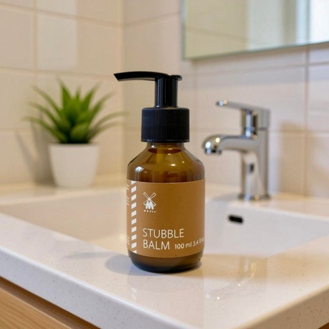 MÜHLE Stubble Balm in it's glass jar placed on a bathroom vanity unit in a clean minimal bathroom setting.