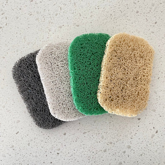 Porous PVC soap saver lift pads elevating a bar of soap to promote drainage and keep the soap dry, suitable for use in a soap dish or directly on a basin.