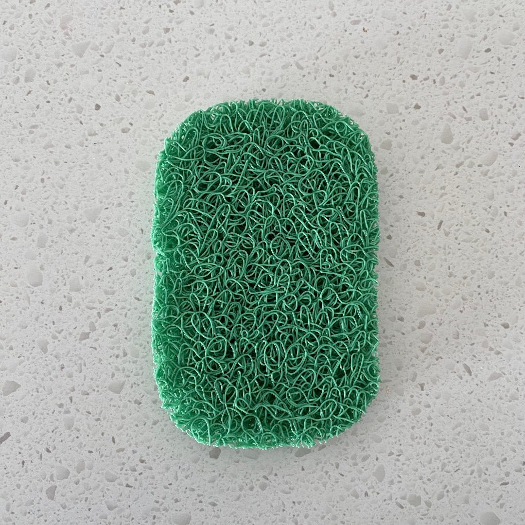 Porous PVC soap saver lift pad elevating a bar of soap to promote drainage and keep the soap dry, suitable for use in a soap dish or directly on a basin.
