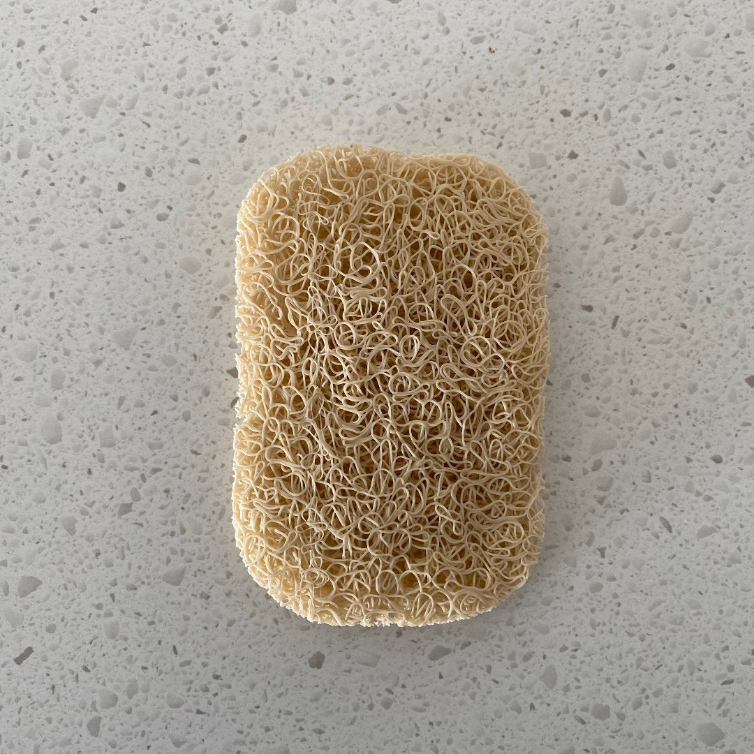 Porous PVC soap saver lift pad elevating a bar of soap to promote drainage and keep the soap dry, suitable for use in a soap dish or directly on a basin.