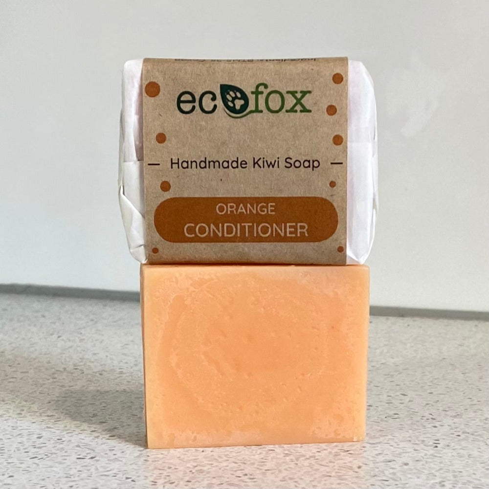 A handmade natural conditioner bar with Orange essential oil.